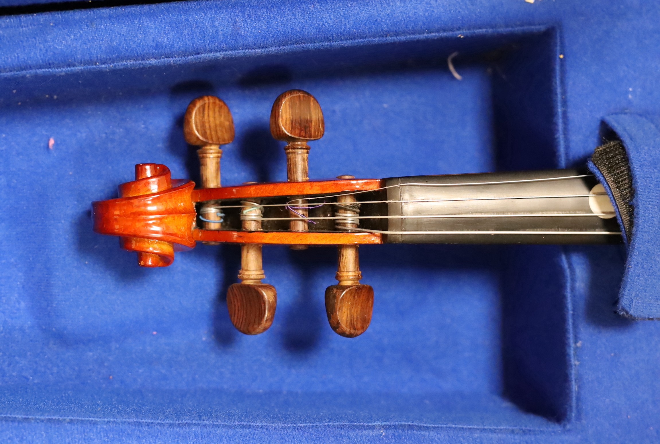 A cased violin and bow